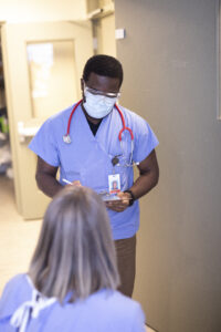 Nurse doing consult with patient at bedside